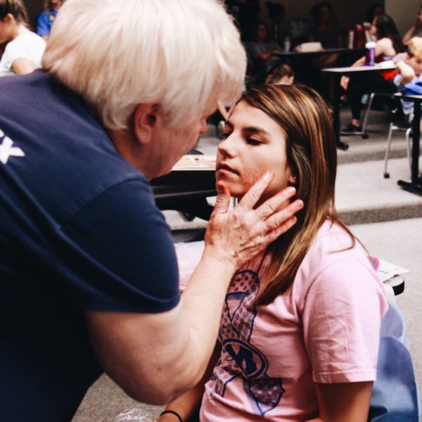 Kettering College student gets moulage (mock wounds) applied to her face