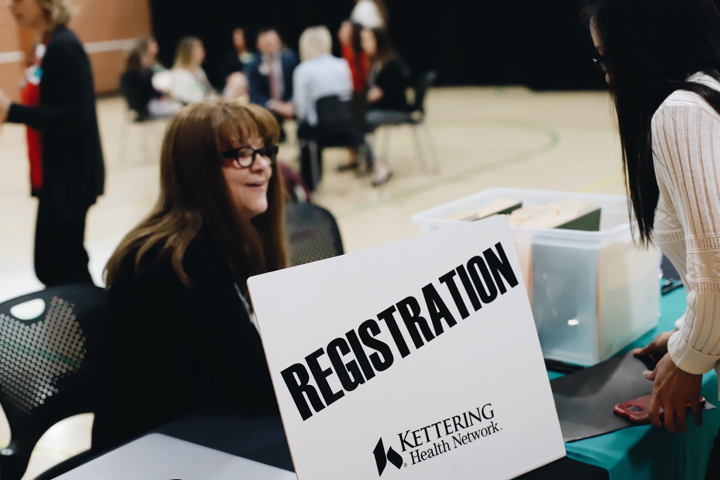 A student checks in at the registration table for Kettering College's BSN interview day with Kettering Health Network nursing managers