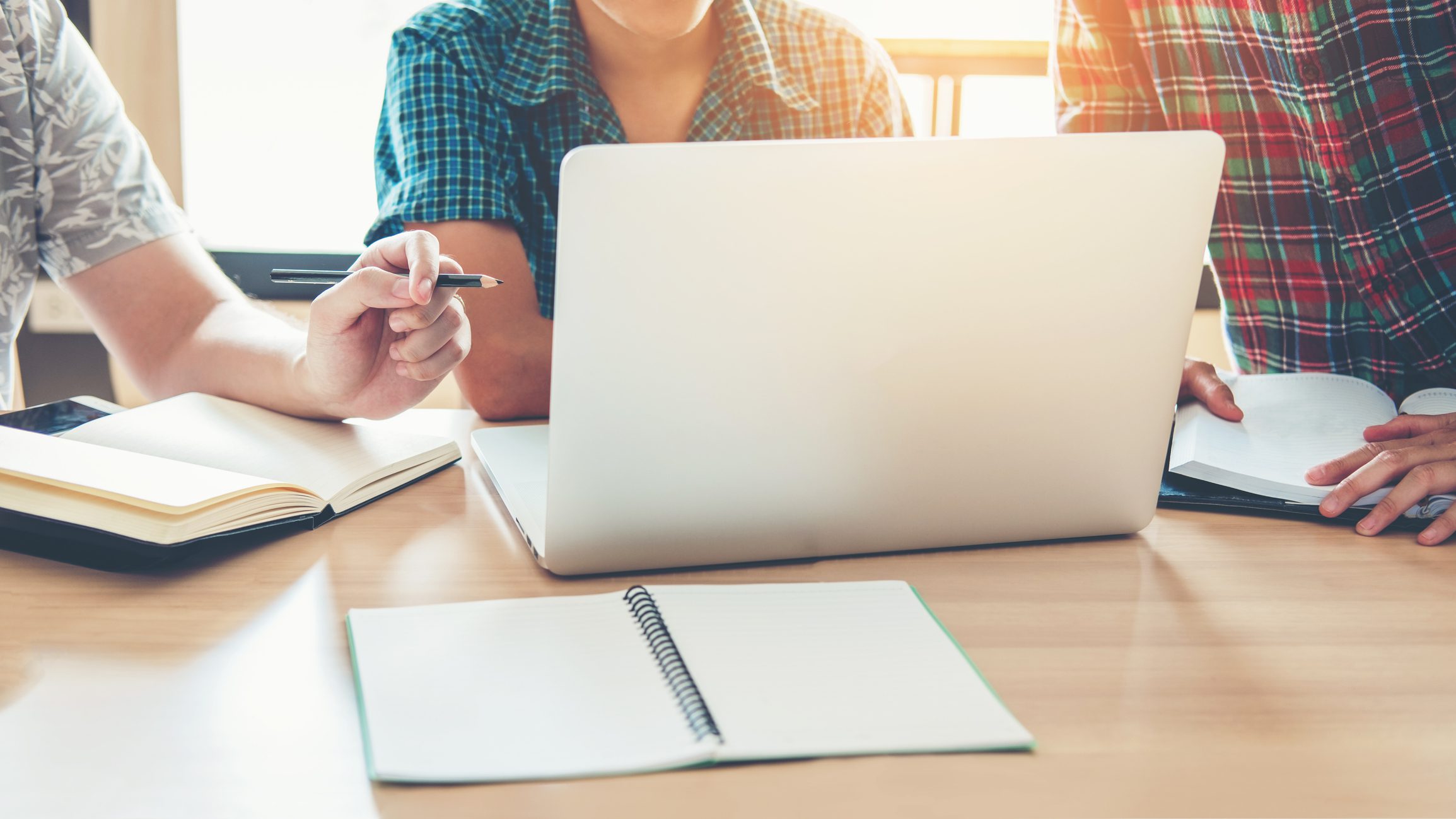 University students using laptop meeting for researching loan default rate in college