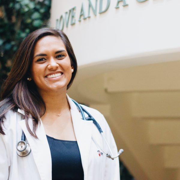 Physician Assistant student posing in her white coat