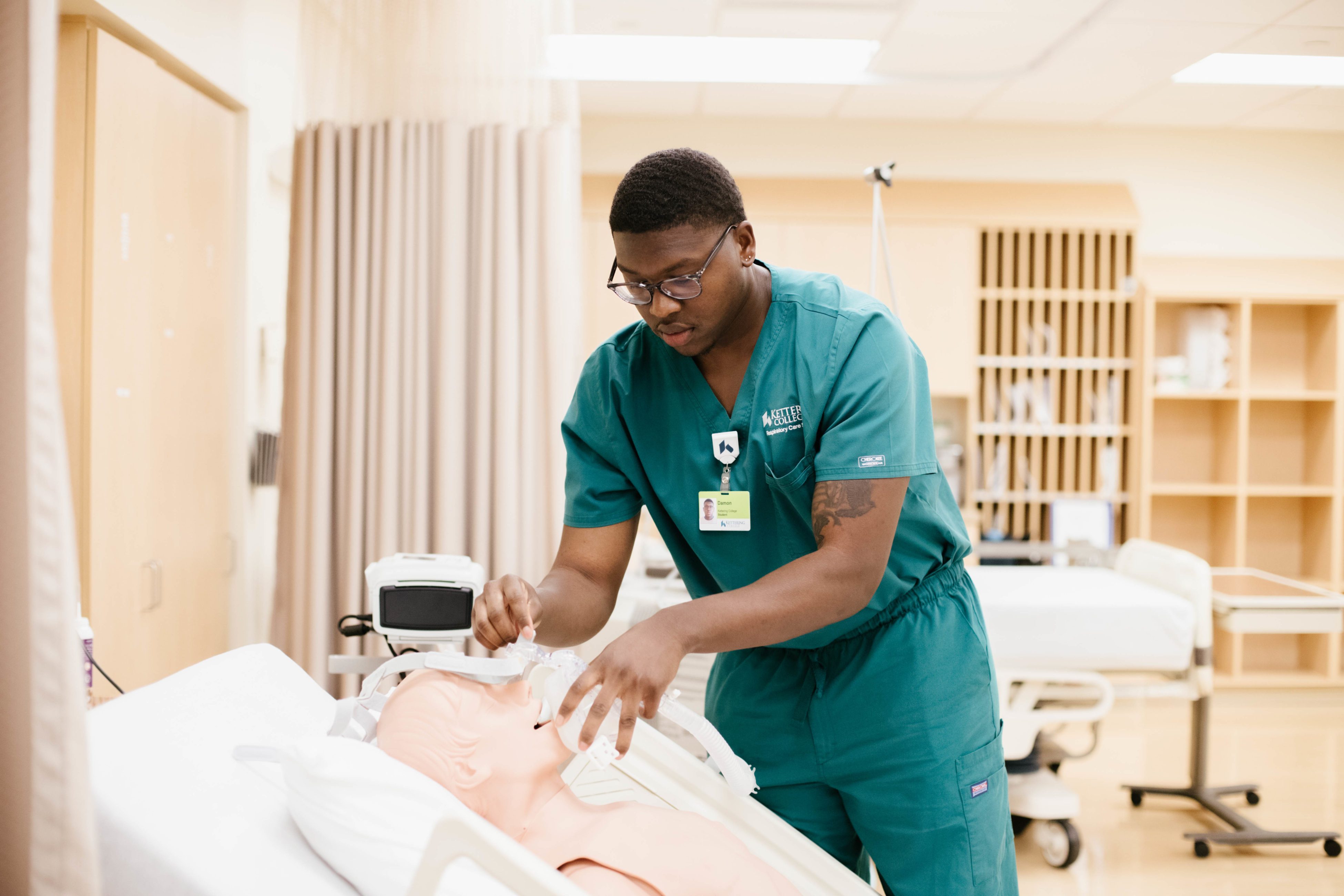 a respiratory care student practices in the respiratory lab