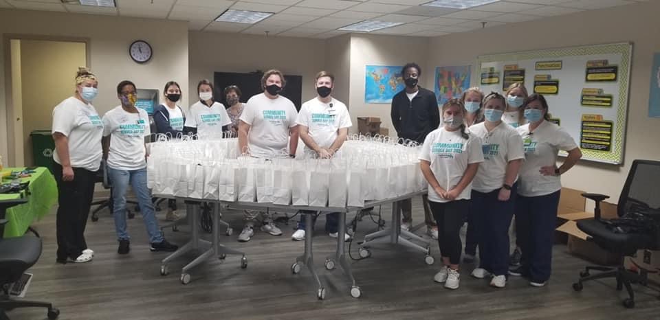 KC Volunteers posing after completing their bags.